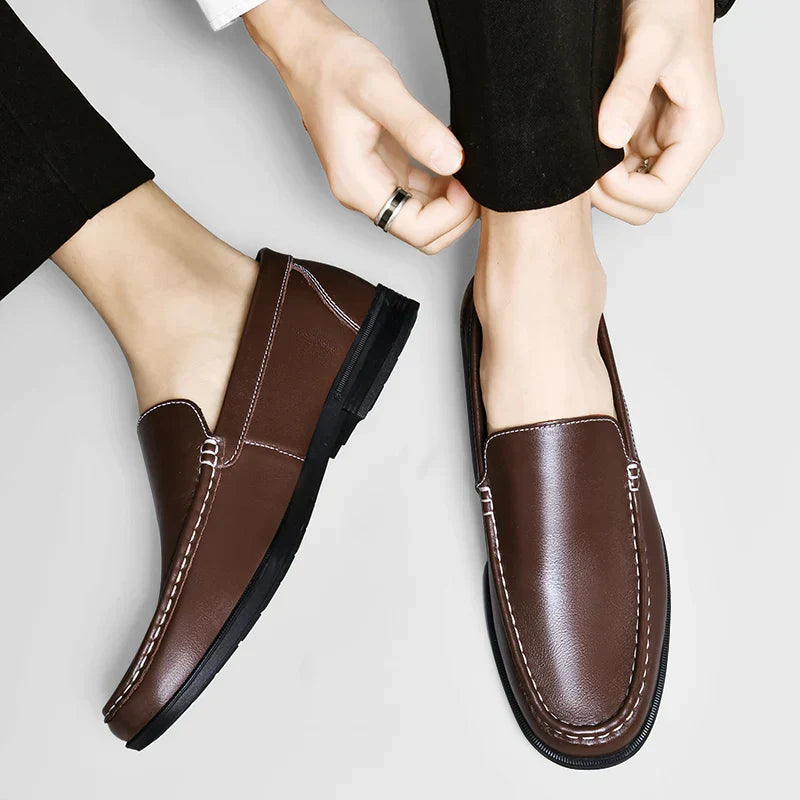 Brown plain-front slip-on dress loafers with moc-toe stitching