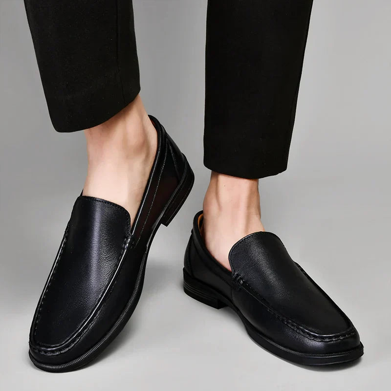 Black plain-front slip-on dress loafers with moc-toe stitching