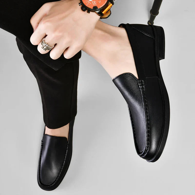 Black plain-front slip-on dress loafers with moc-toe stitching