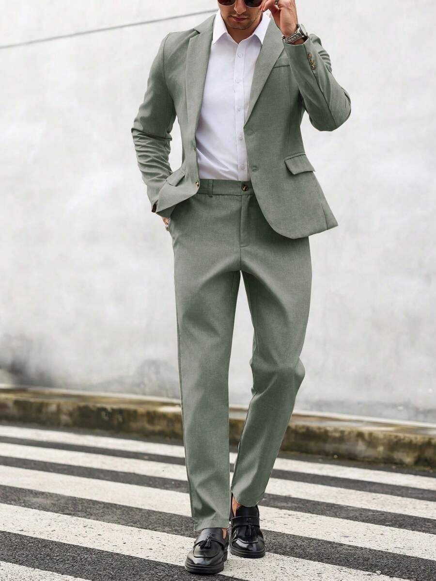 Man wearing an olive-green suit with a white shirt, walking front view