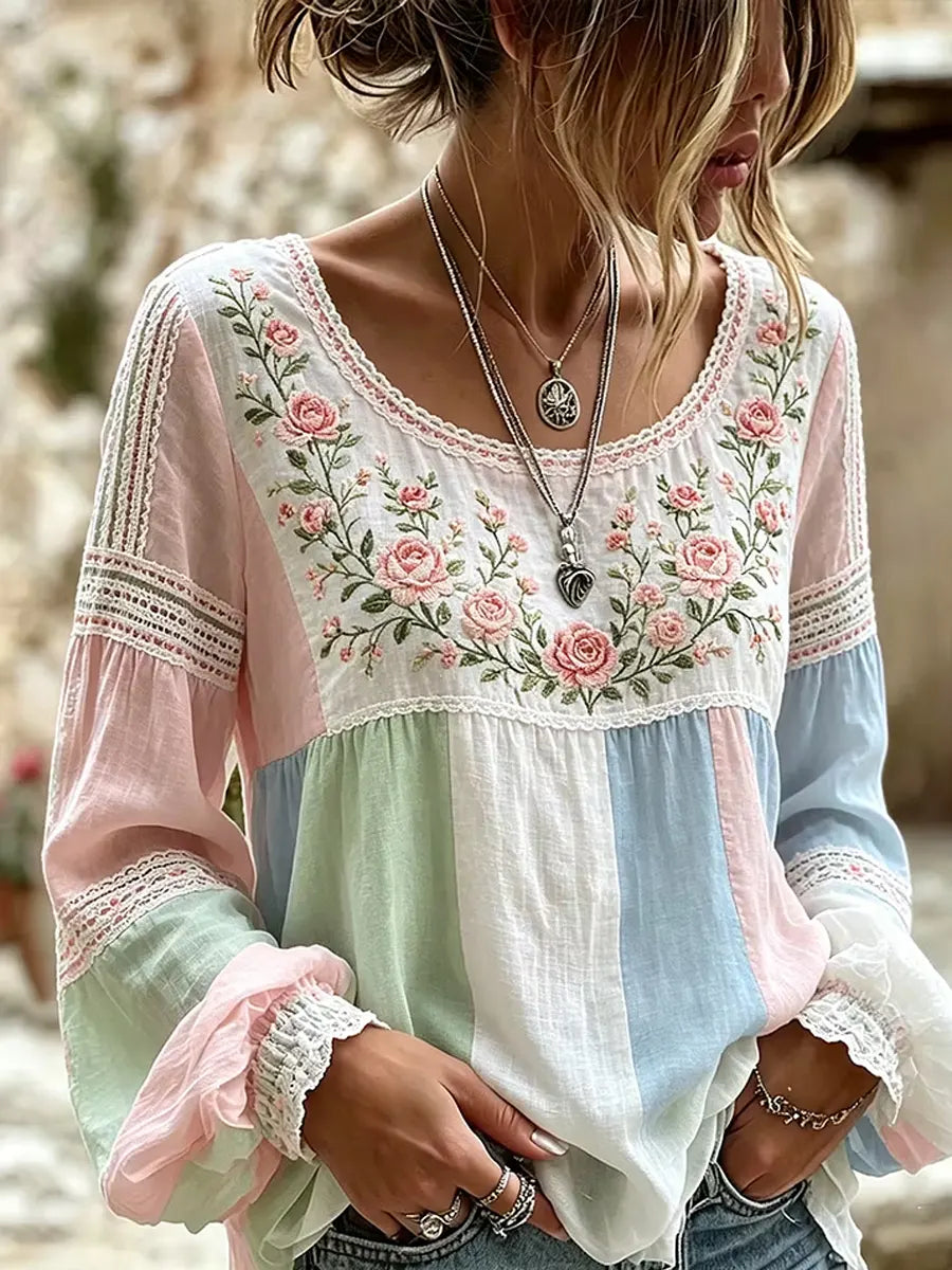 Pastel multicolour blouse with rose embroidery, a rounded neckline and lace-trimmed sleeves
