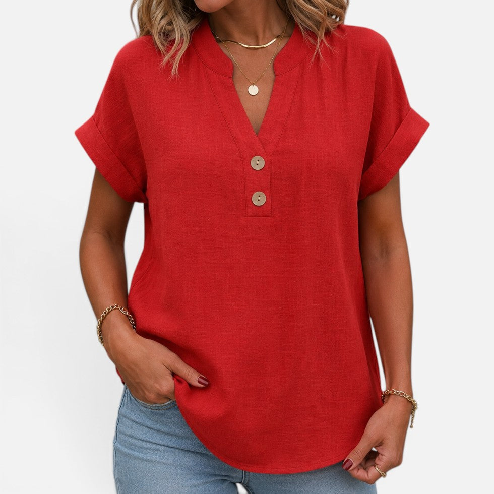 Woman wearing a red short-sleeve blouse with a V-notch button placket, front view