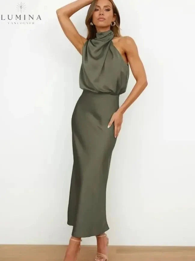Woman wearing a dark olive-green draped halter-neck midi dress, front view