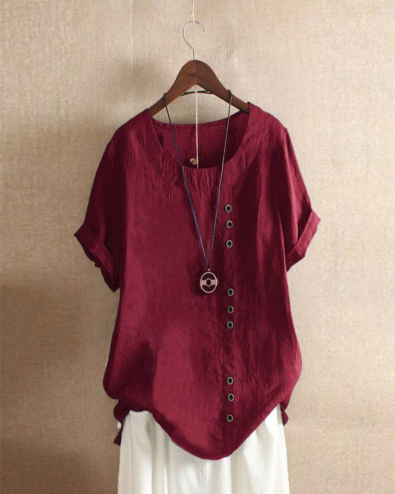 Light beige Beatrice casual blouse with relaxed fit and button details, styled with rolled sleeves.