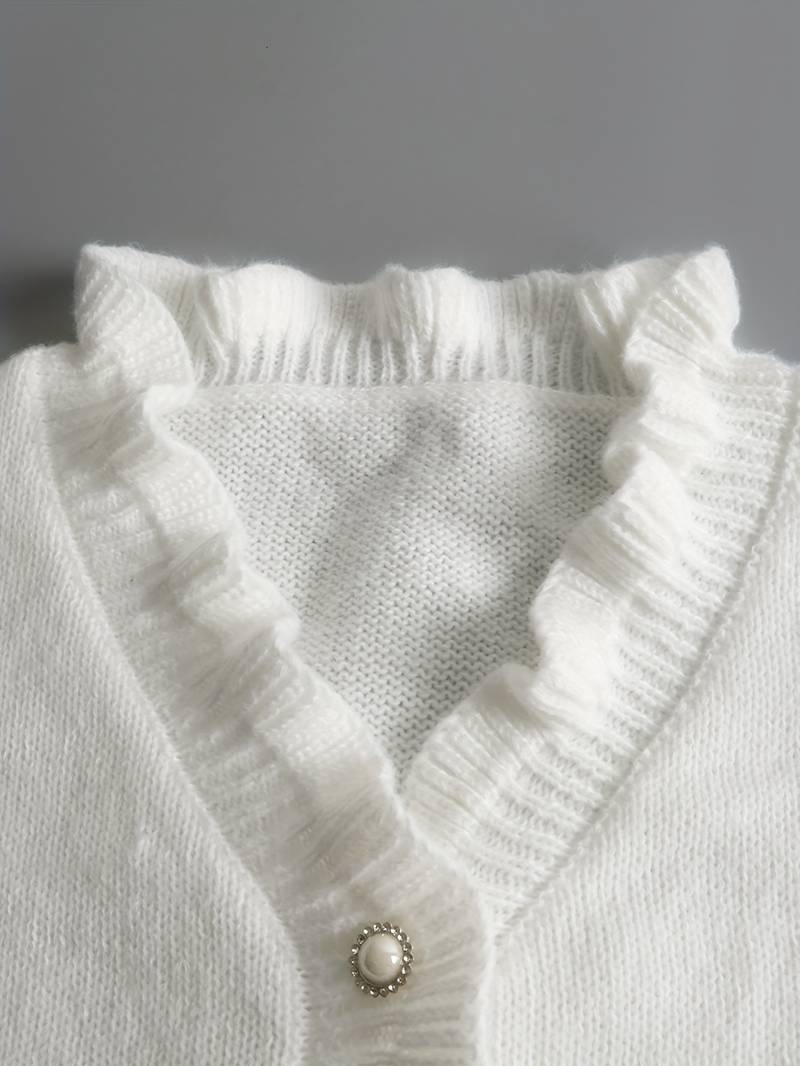 Elegant Victoria blouse with ruffle design and decorative buttons, perfect for stylish women's fashion.