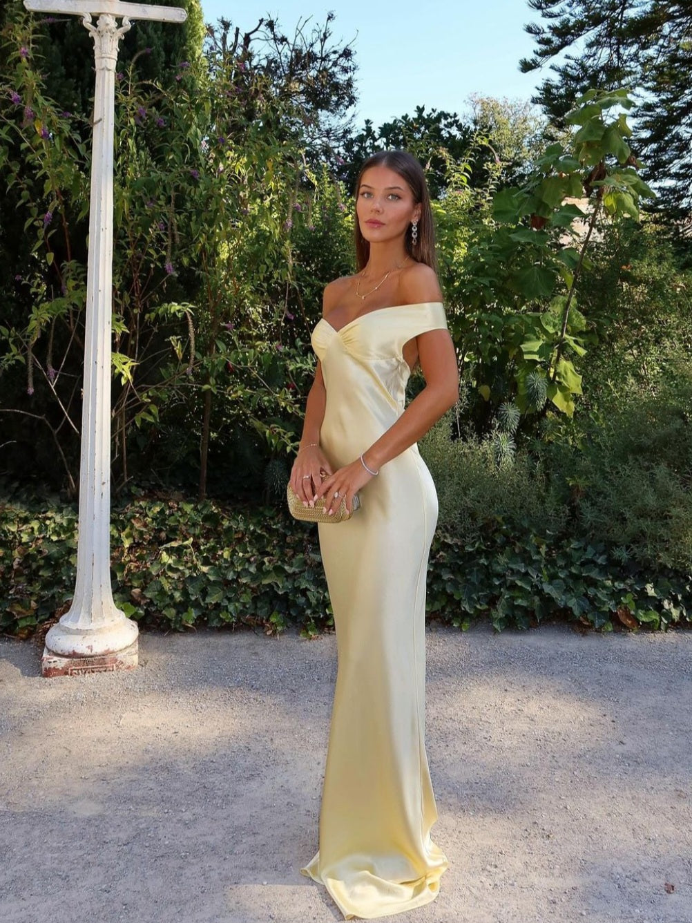 Champagne off-the-shoulder maxi dress with a fitted bodice and flowing skirt