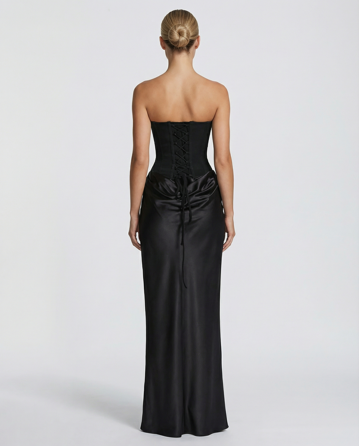 Back view of black strapless maxi dress showing lace-up corset bodice.