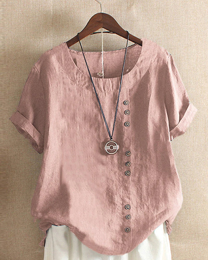 Light beige Beatrice summer blouse featuring relaxed fit and button details, displayed on a hanger.