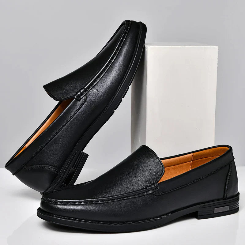 Black plain-front slip-on dress loafers with moc-toe stitching