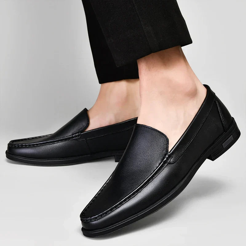 Black plain-front slip-on dress loafers with moc-toe stitching