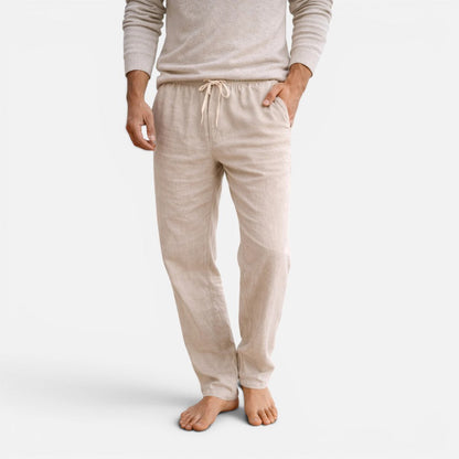 Man wearing beige straight-leg drawstring trousers