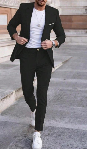 Man wearing a black suit with a white T-shirt