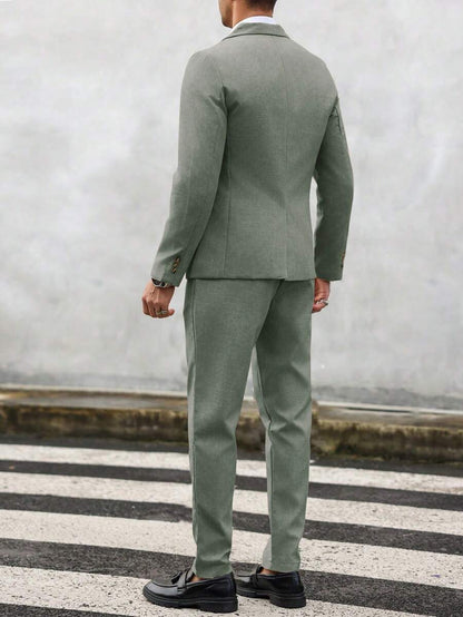 Man wearing an olive-green tailored suit with matching jacket and trousers, rear view
