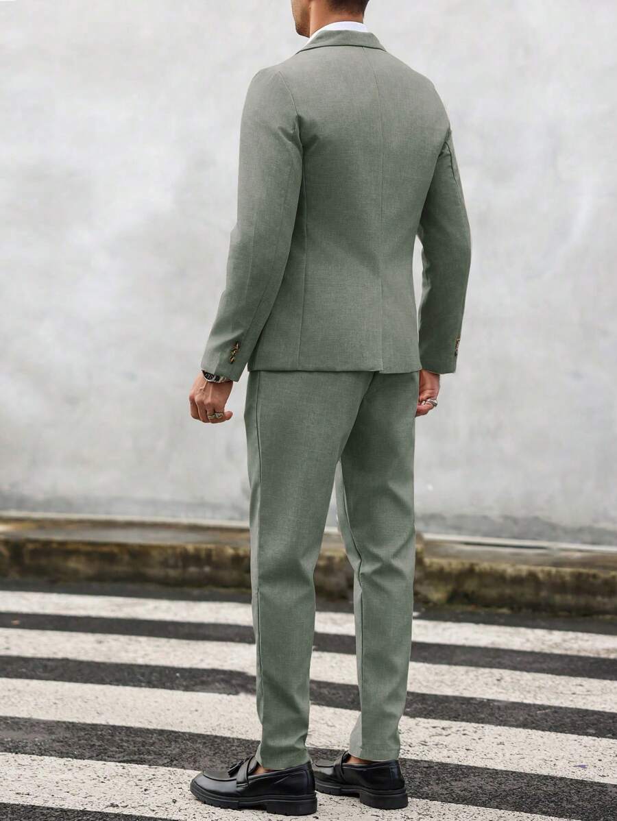 Man wearing an olive-green tailored suit with matching jacket and trousers, rear view