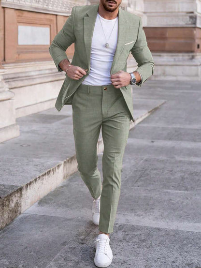 Man wearing an olive-green suit with a white T-shirt, street front view