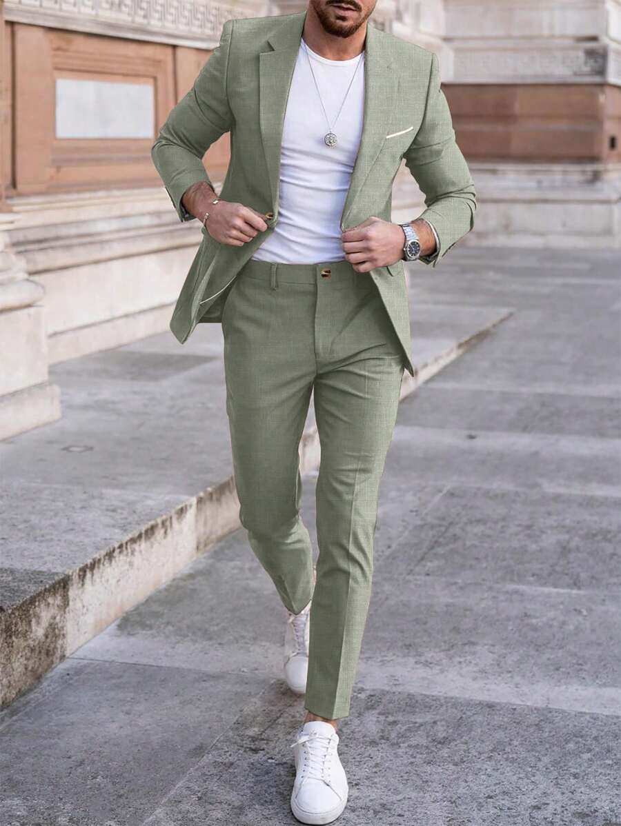 Man wearing an olive-green suit with a white T-shirt, street front view