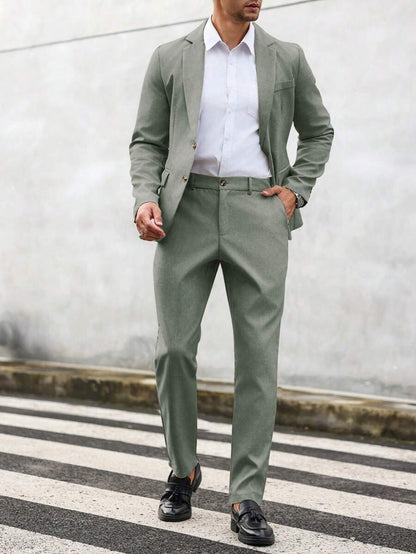 Man wearing an olive-green suit with a white shirt, front view