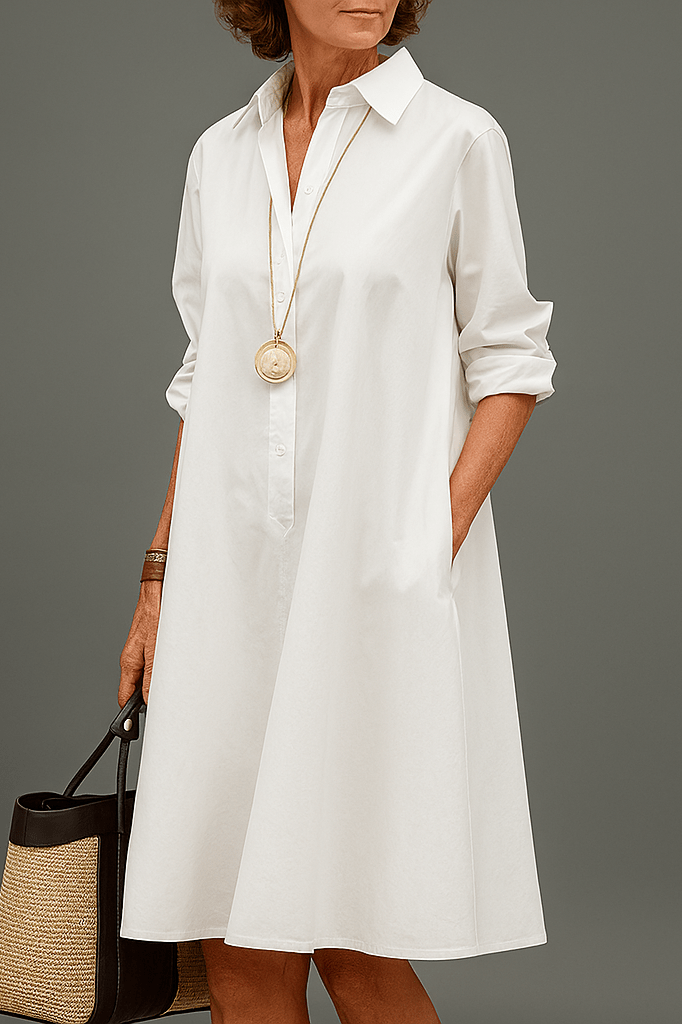 White A-line dress with a button front and side pockets