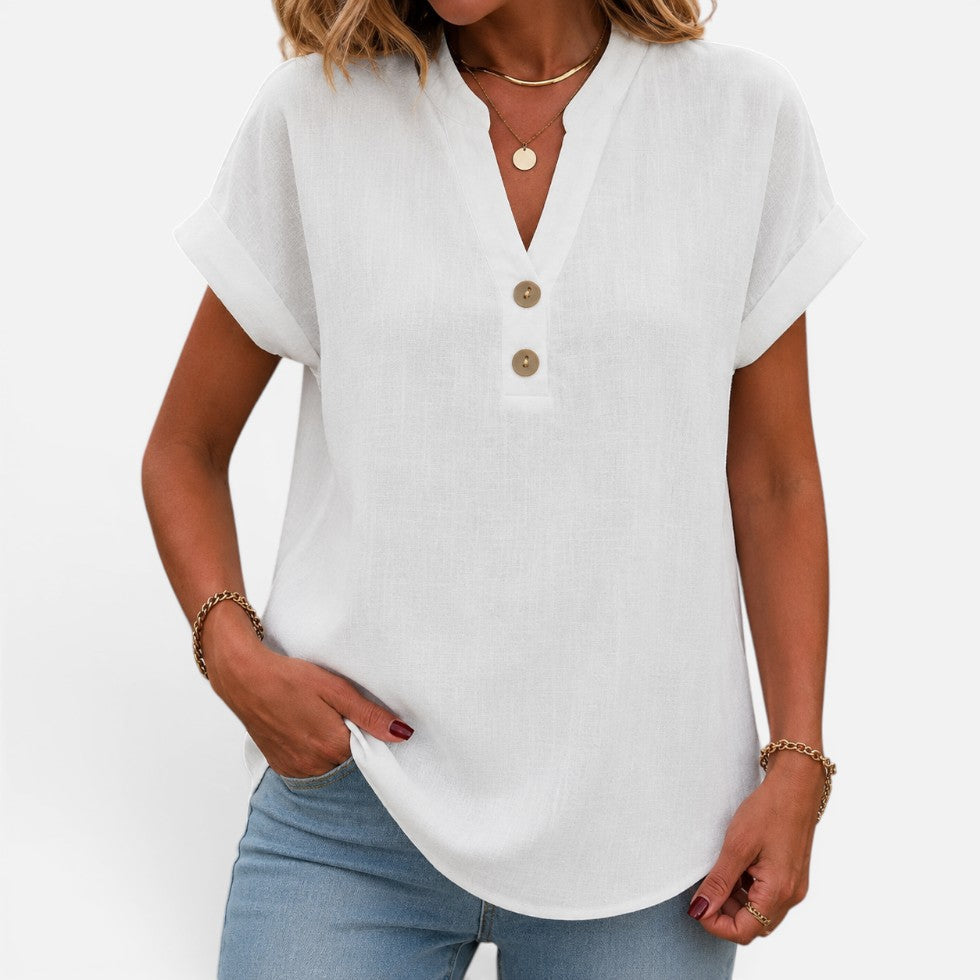 Woman wearing a white short-sleeve blouse with a V-notch button placket, front view