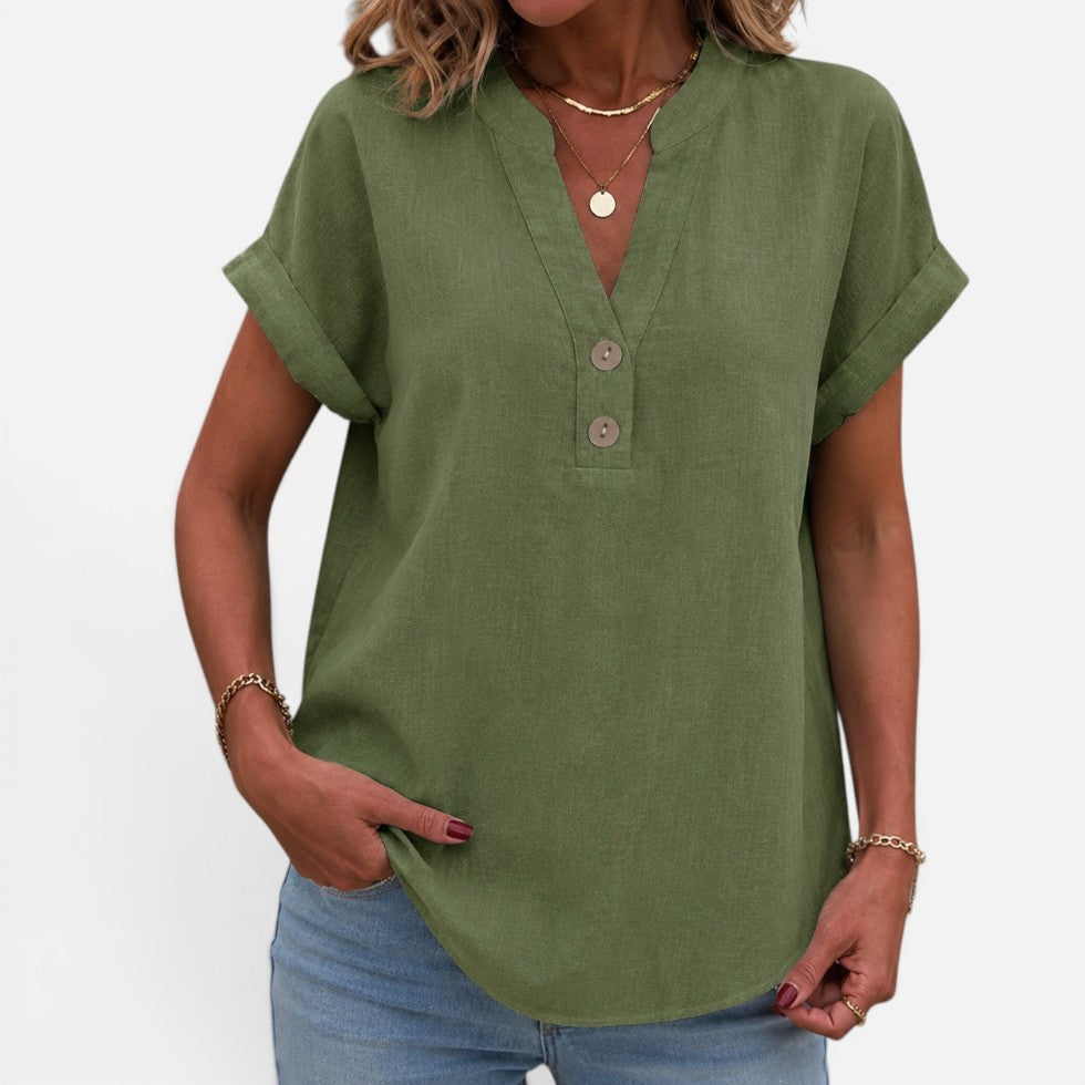 Woman wearing an olive green short-sleeve blouse with a V-notch button placket, front view