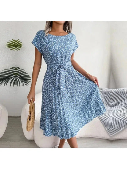 Blue Anabelle floral pleated midi dress, featuring a flowing, feminine design with a fitted waist and elegant silhouette.