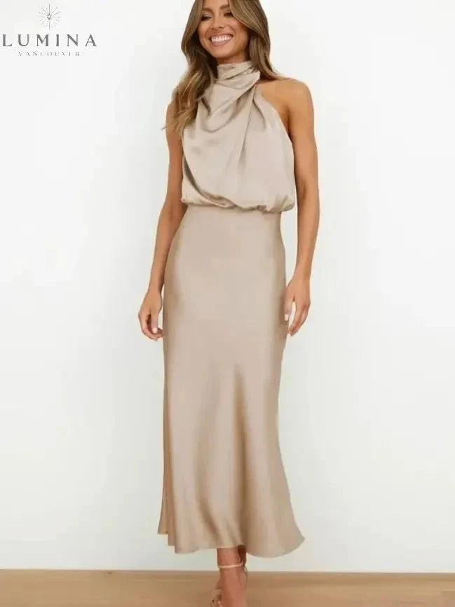 Woman wearing a khaki draped halter-neck midi dress, front view
