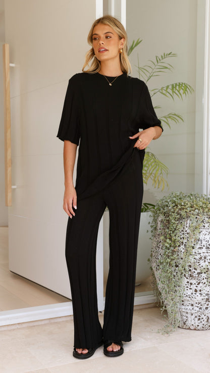 Woman wearing black Bayu ribbed-knit wide-leg pants, front view