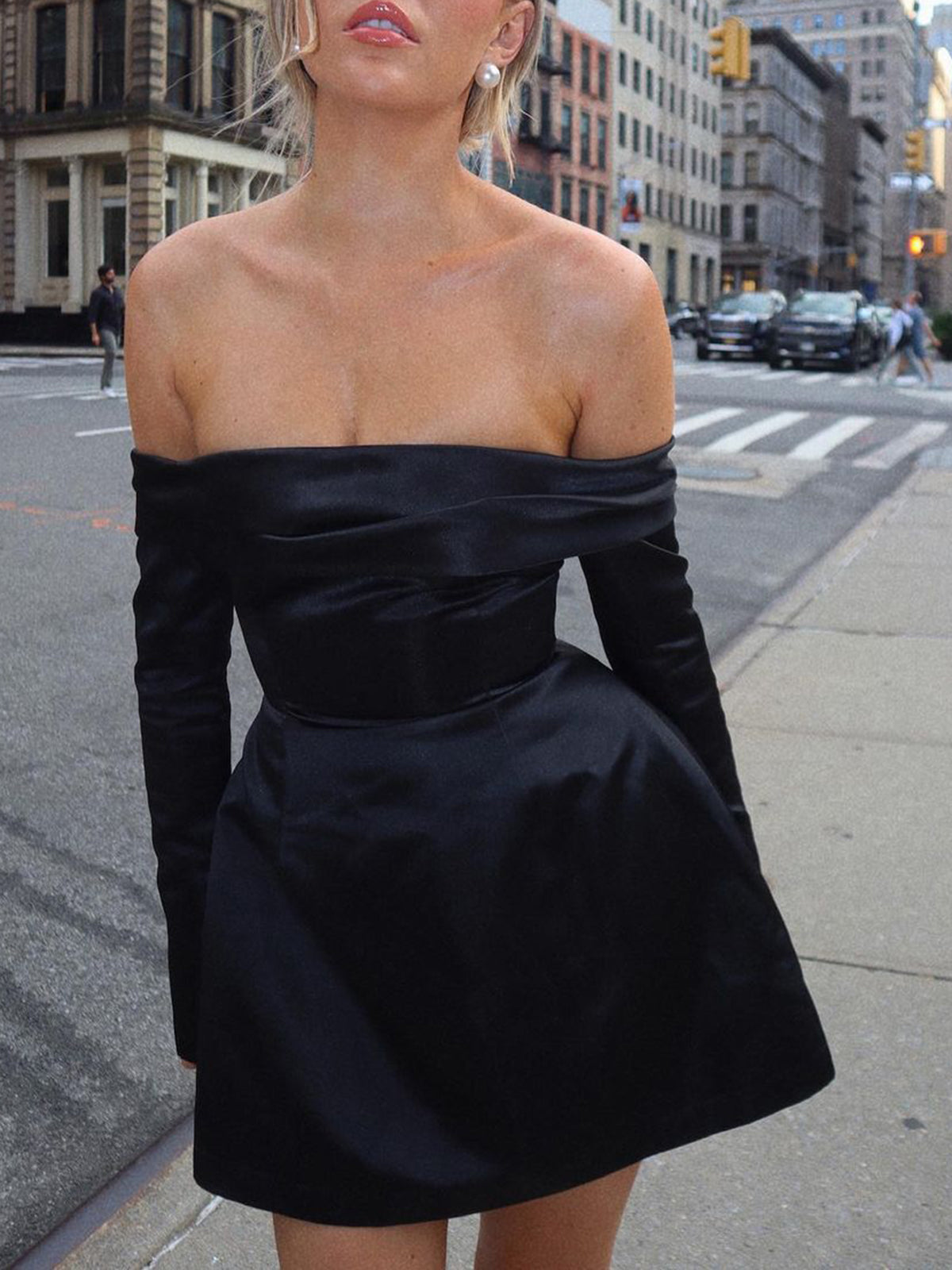 Black off-the-shoulder mini dress with long sleeves and a flared skirt