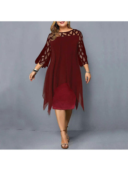 Woman wearing a burgundy-red dress with geometric sheer sleeves, front view