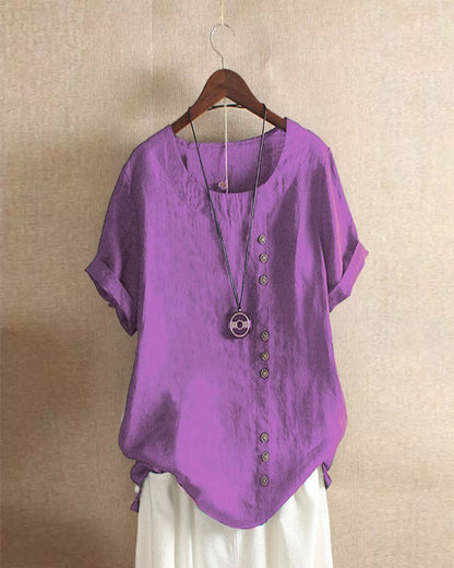 Light beige Beatrice casual blouse with relaxed fit and button details, displayed on a hanger against a neutral background.