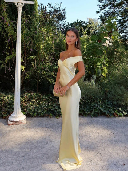 Champagne off-the-shoulder maxi dress with a fitted bodice and flowing skirt