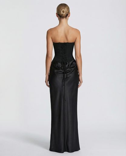 Back view of black strapless maxi dress showing lace-up corset bodice.