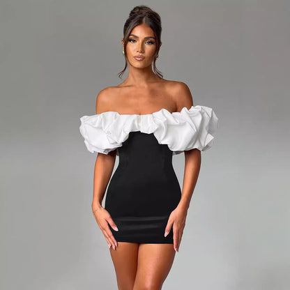Black and white Aurora off-shoulder mini dress, featuring a stylish, fitted silhouette and elegant neckline.