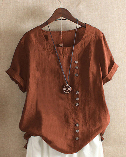 Light blue Beatrice summer blouse featuring relaxed fit and button detail, displayed on a hanger.