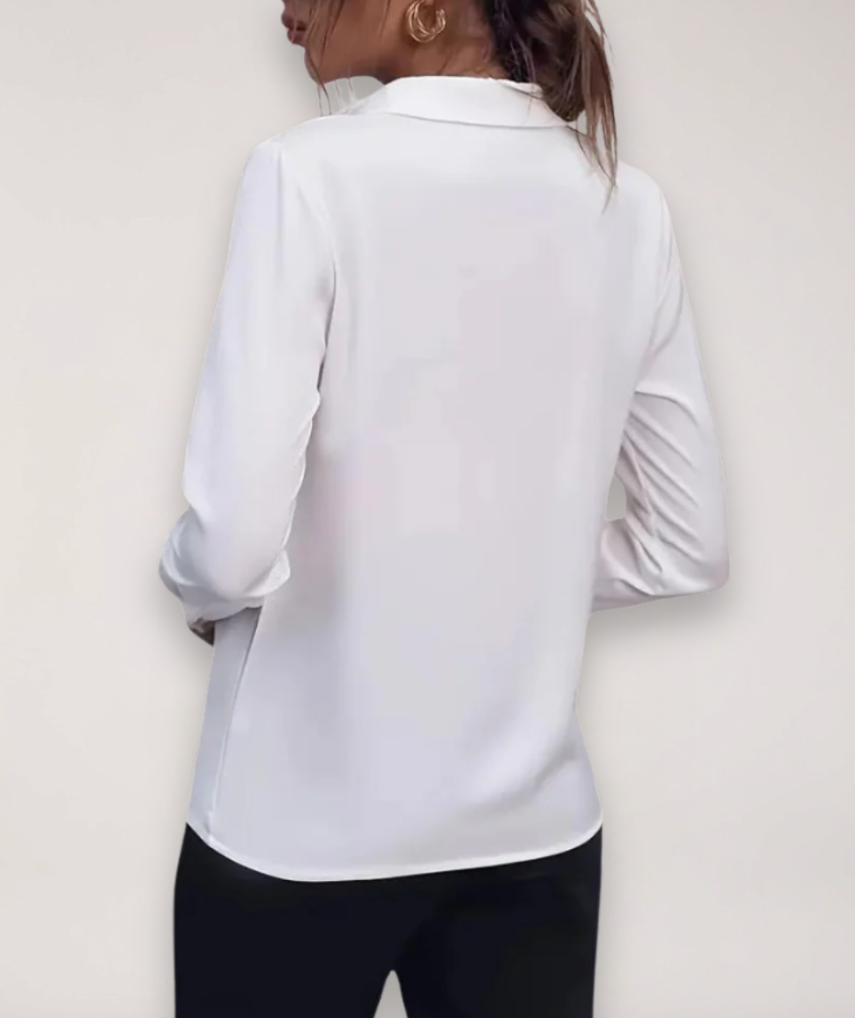 Elegant tailored women's blouse featuring a button-up front and classic design in a light fabric.
