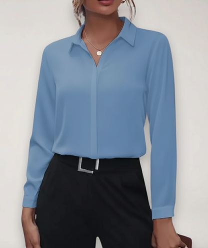 Elegant white tailored women's blouse with button-up front and long sleeves, styled for a sophisticated look.