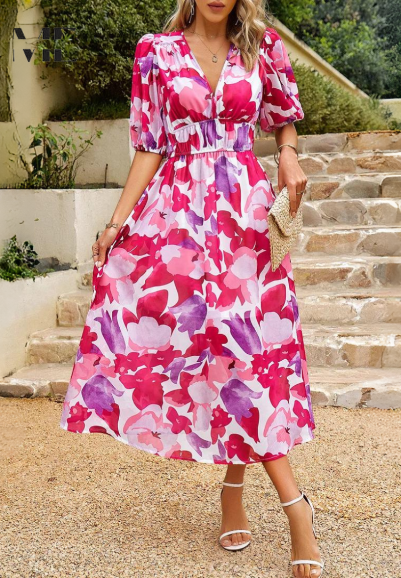 Woman wearing a pink-and-white floral V-neck midi dress, front view